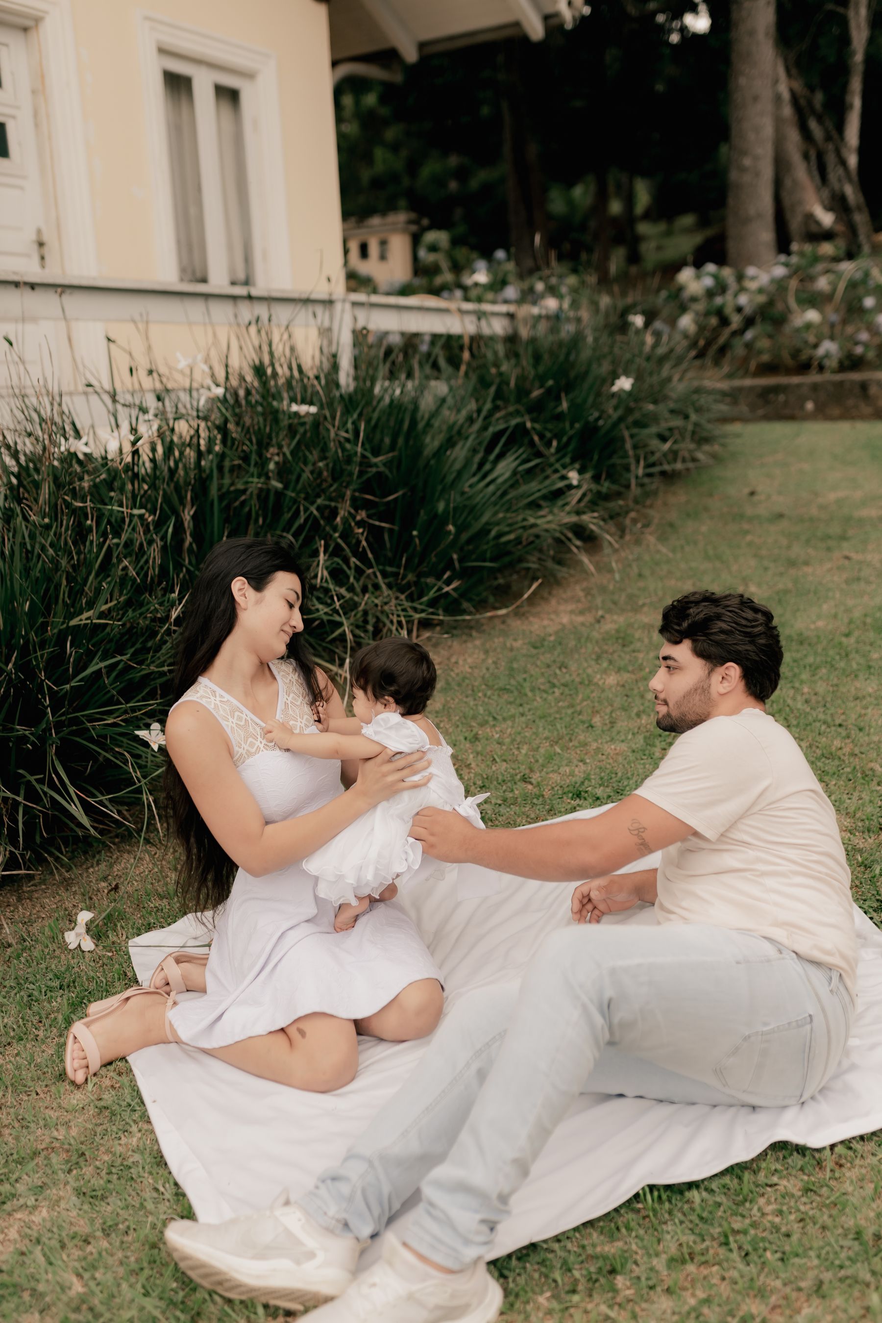 A family relaxing together in the garden of their home